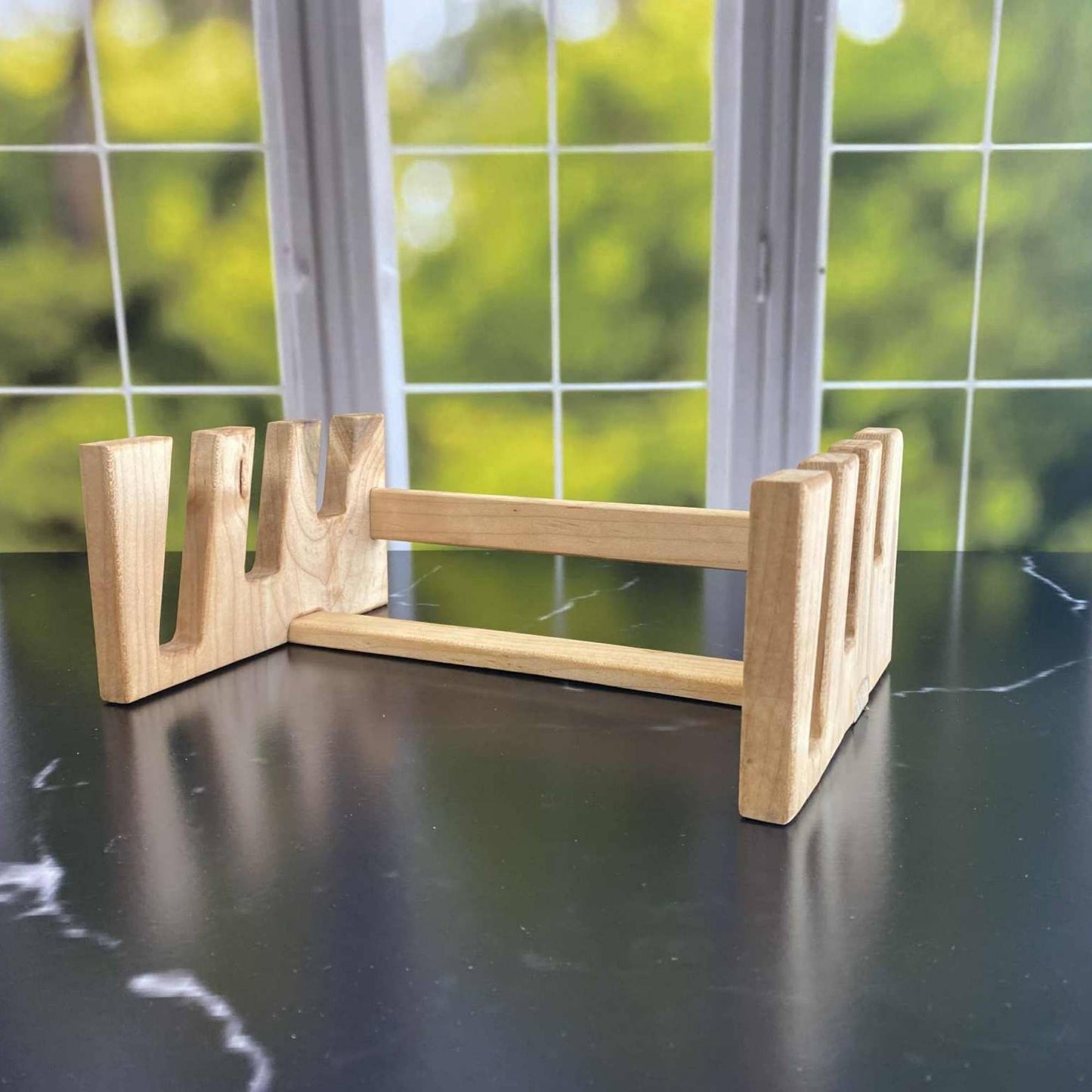 wood serving board stand sitting on the counter