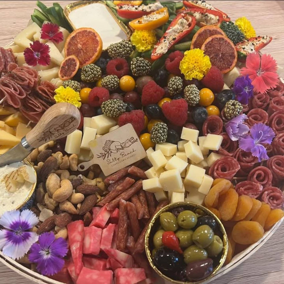 Charcuterie platter with meats, cheeses, fruits and more.