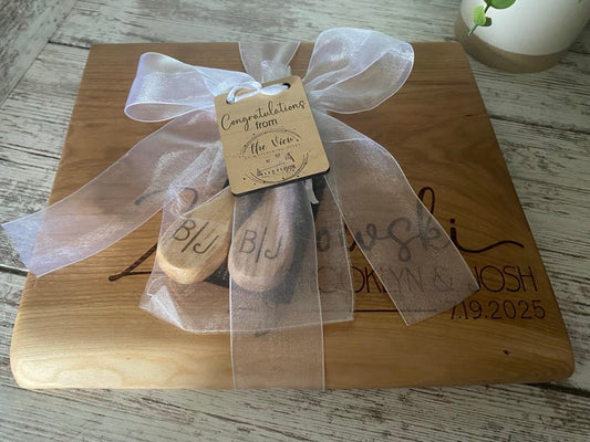 Live edge cherry serving board wrapped with a white bow and gift tag, handcrafted as a wedding or housewarming gift