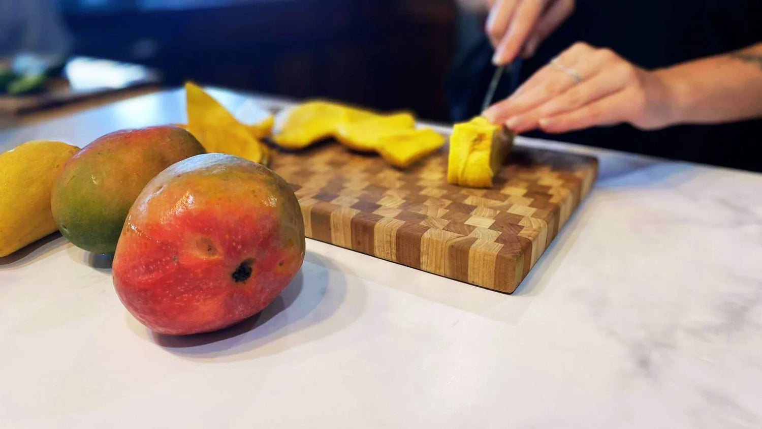 end grain cutting board being used in the kitchen for food prep