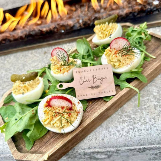 Charcuterie board shaped food tag custom engraved with company logo and placed on serving dish