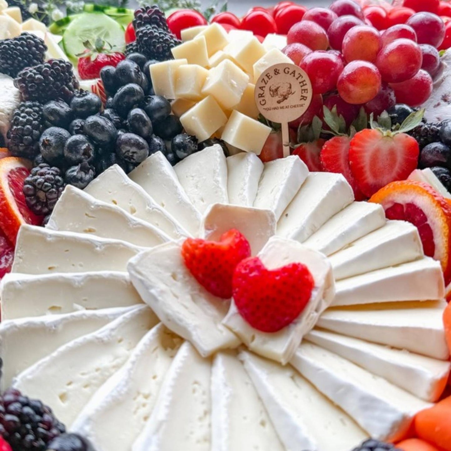 round wood charcuterie food pick on a fruit platter