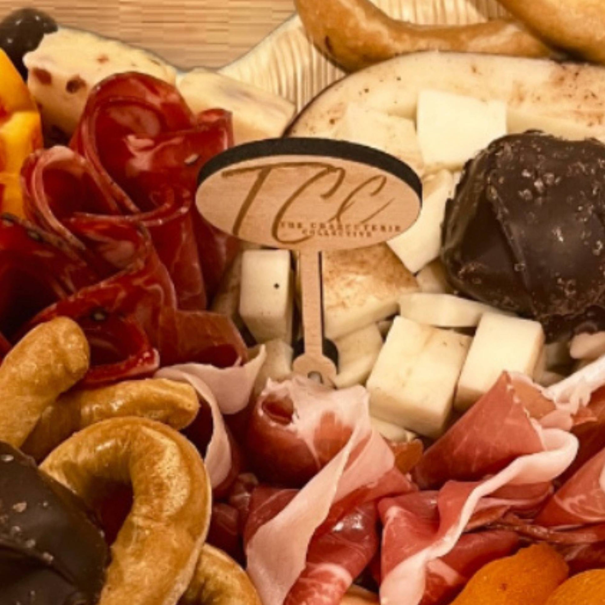 wood oval charcuterie food pick custom engraved on a charcuterie spread