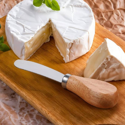 charcuterie knife sitting on serving board with brie cheese