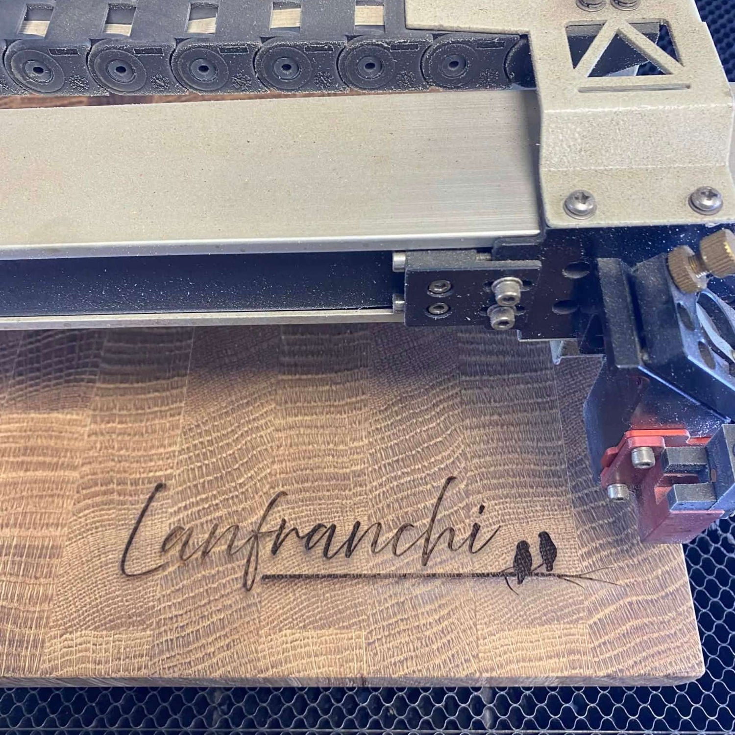 Handcrafted wood end grain board being engraved in an Ohio-based artisan shop