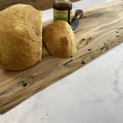 Close-up of hickory live edge serving board showing natural grain and edge
