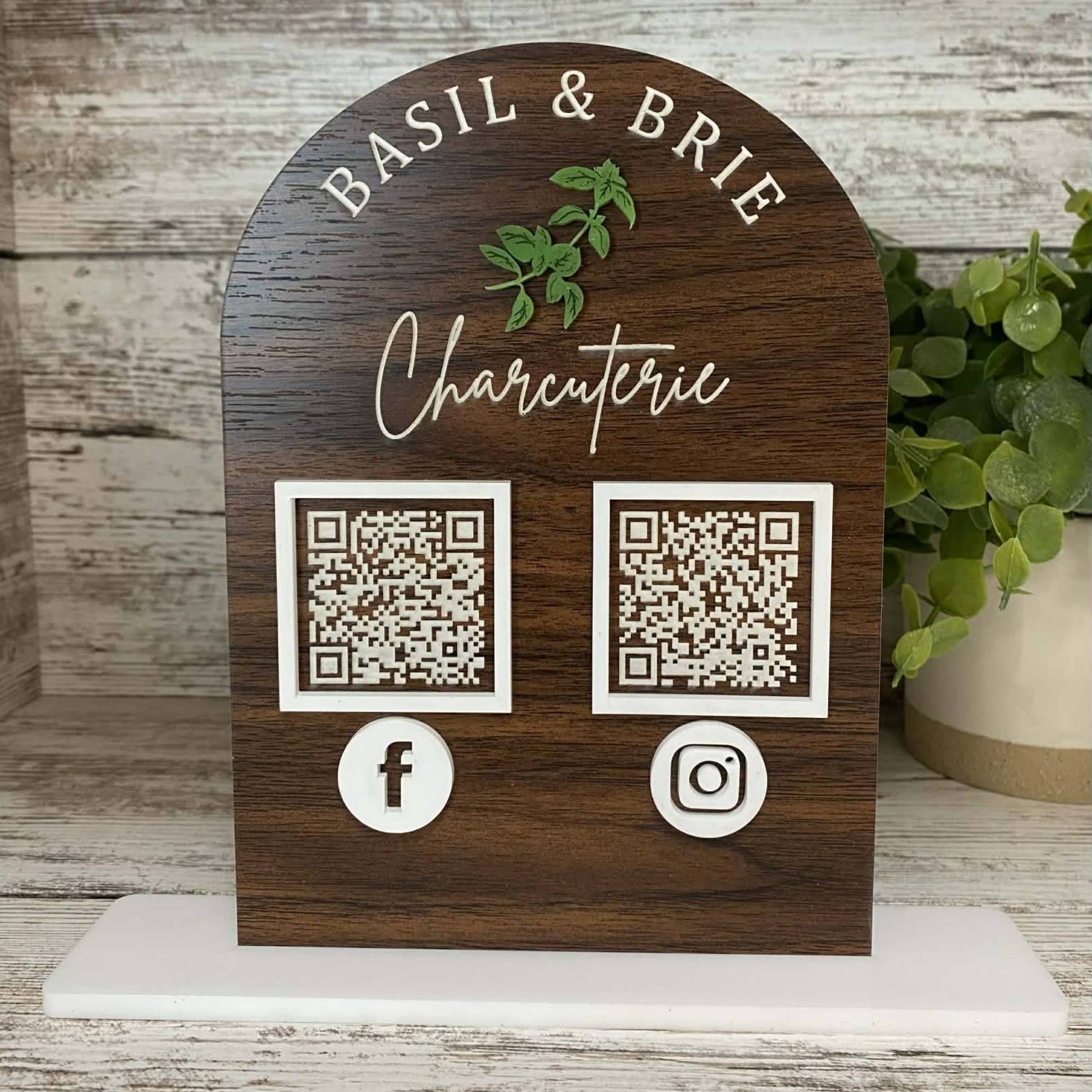 dark wood business QR code sign with white accents sitting on shelf