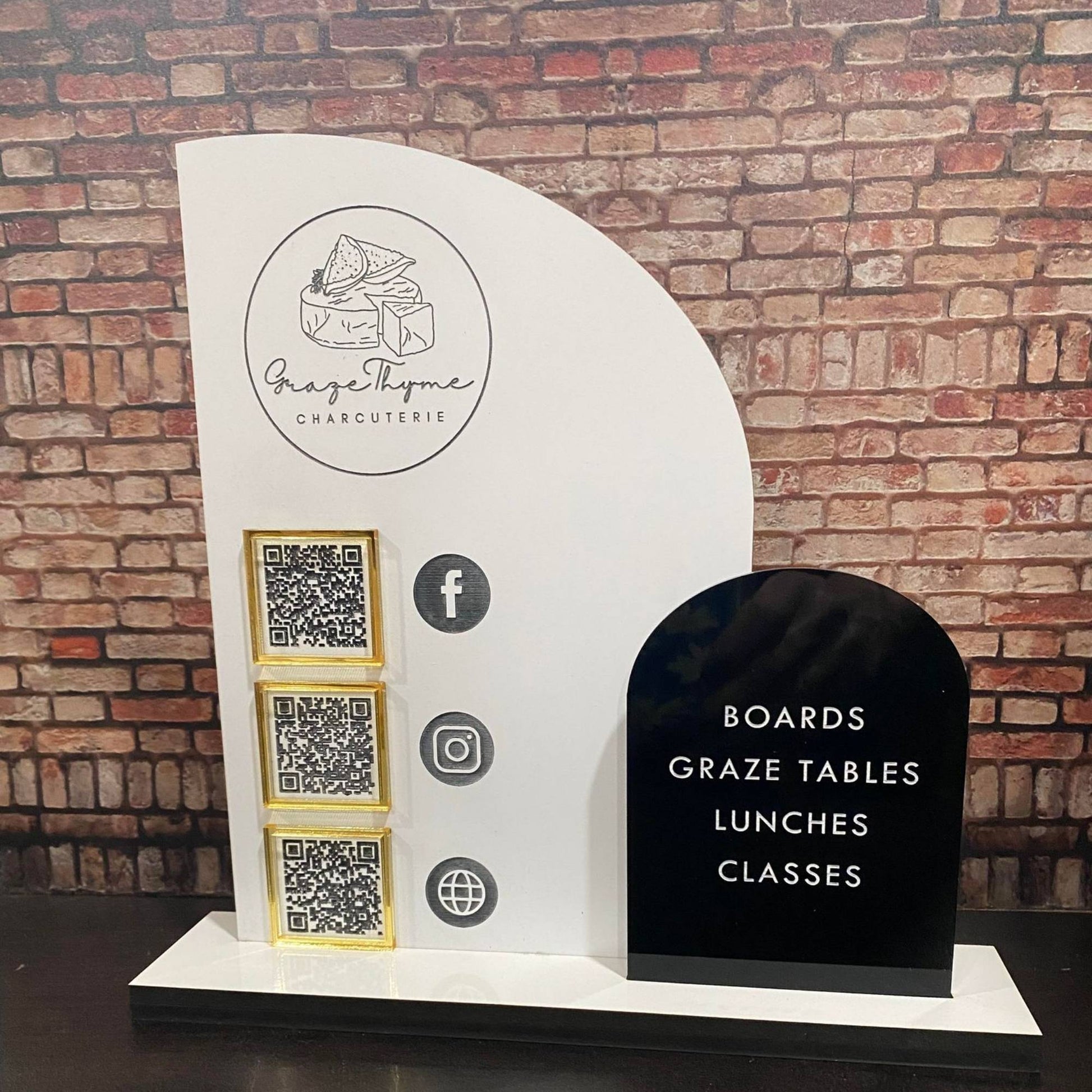 Business sign with a half arch and full arch layered acrylic pieces featuring QR codes and logo