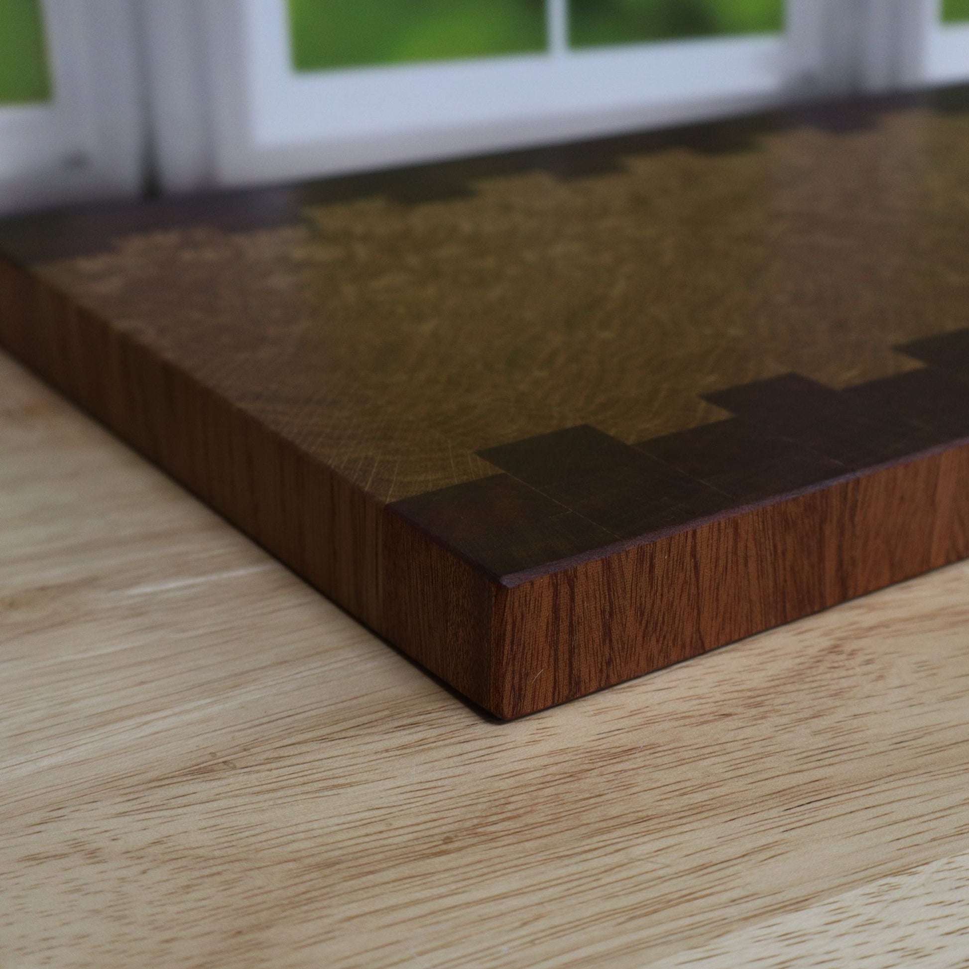 Side view of handcrafted Sapele and White Oak end grain cutting board