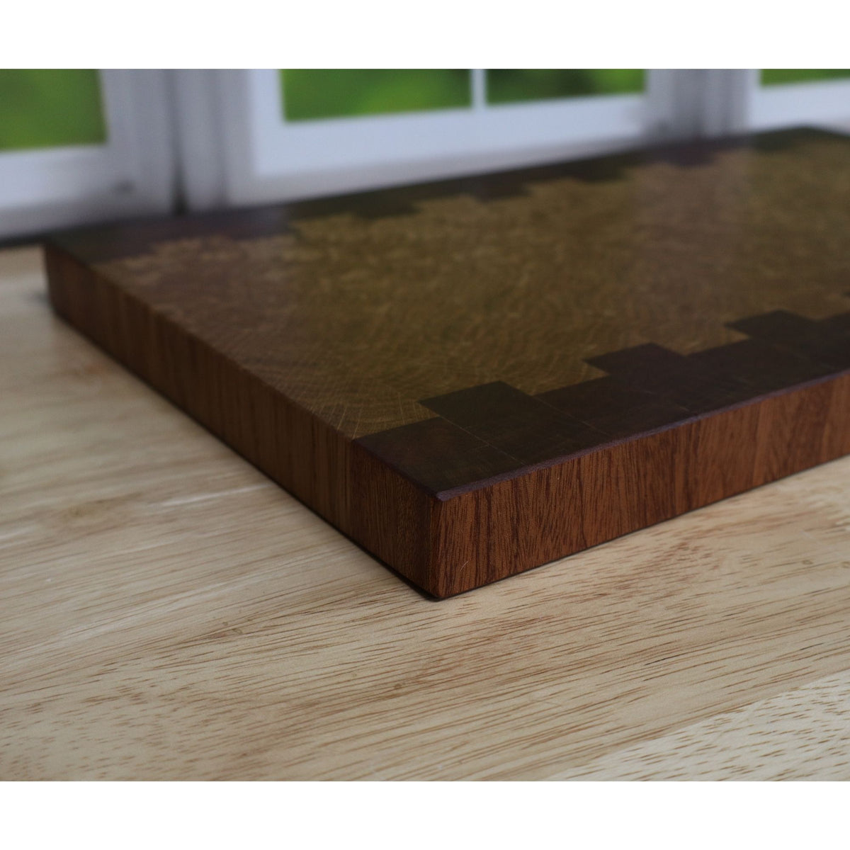 side view of handcrafted Sapele and White Oak end grain cutting board 