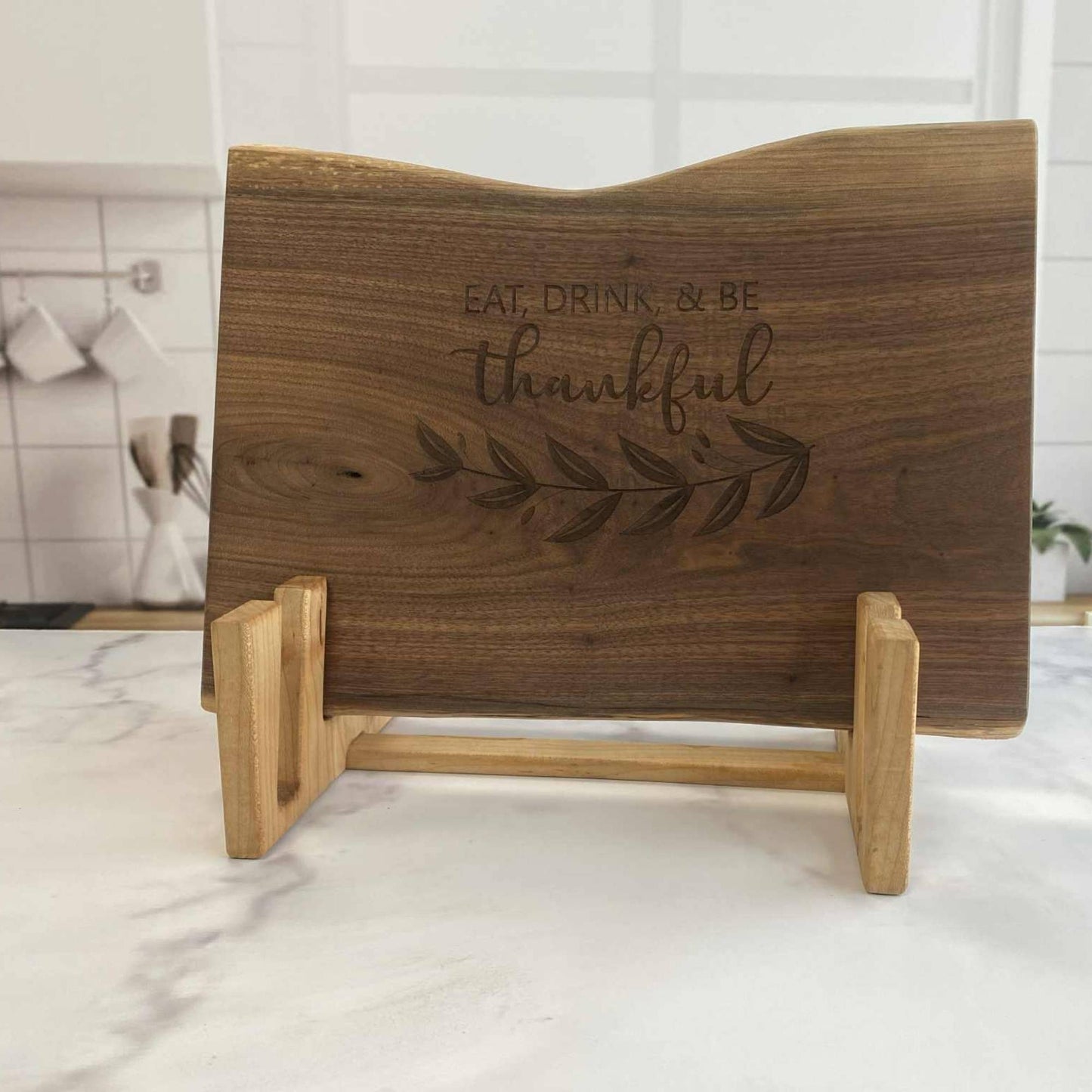 wood serving board stand holding one walnut live edge board