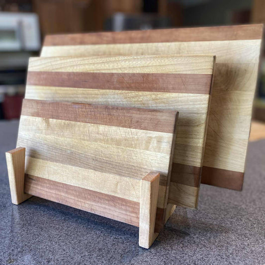 wood serving board stand holding three serving boards