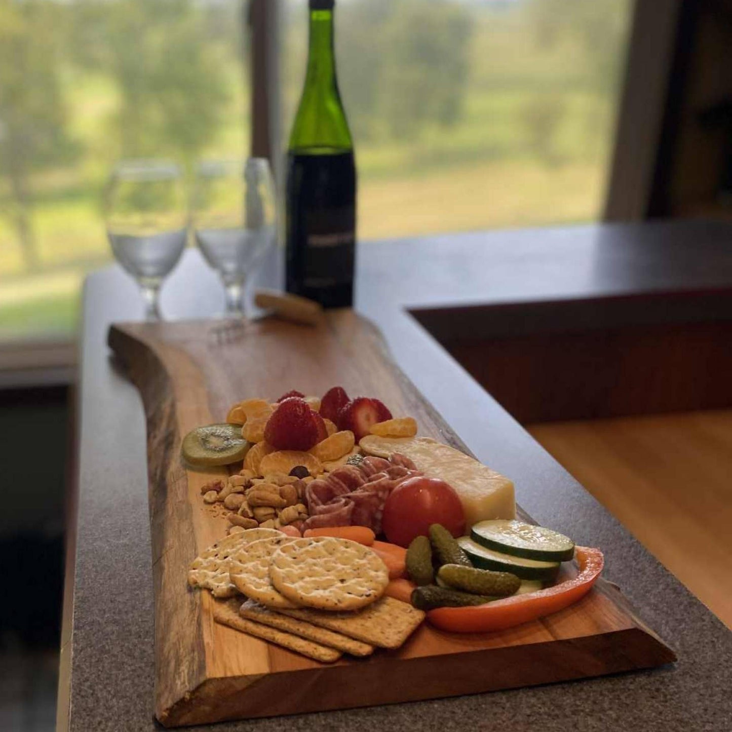 live edge cherry board showing a small charcuterie display