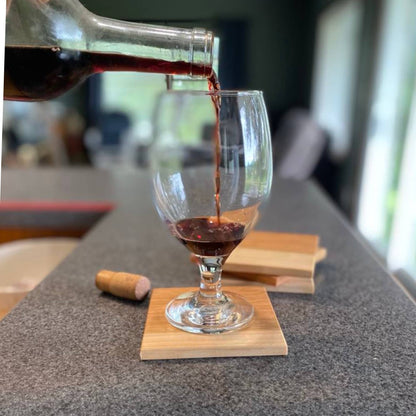 hardwood cherry coasters on kitchen countertop with wine glass