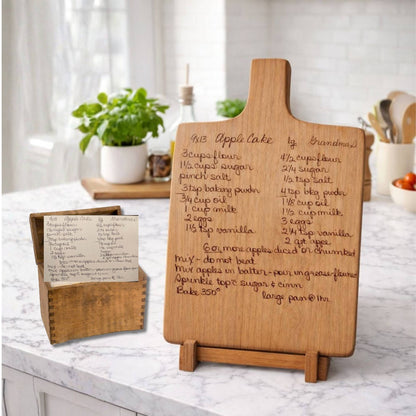 custom engraved recipe board on a wood stand sitting next to the recipe box with the recipe card