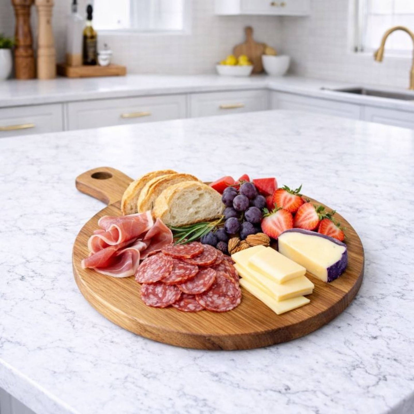 round wood serving board on kitchen island with charcuterie food