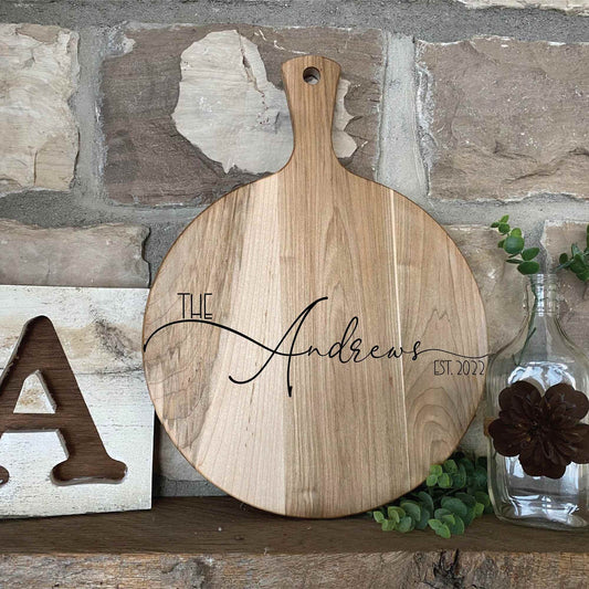 round wood serving board displayed on shelf