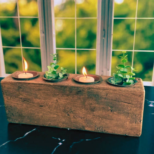 hand carved sugar mold with lit candles and plants
