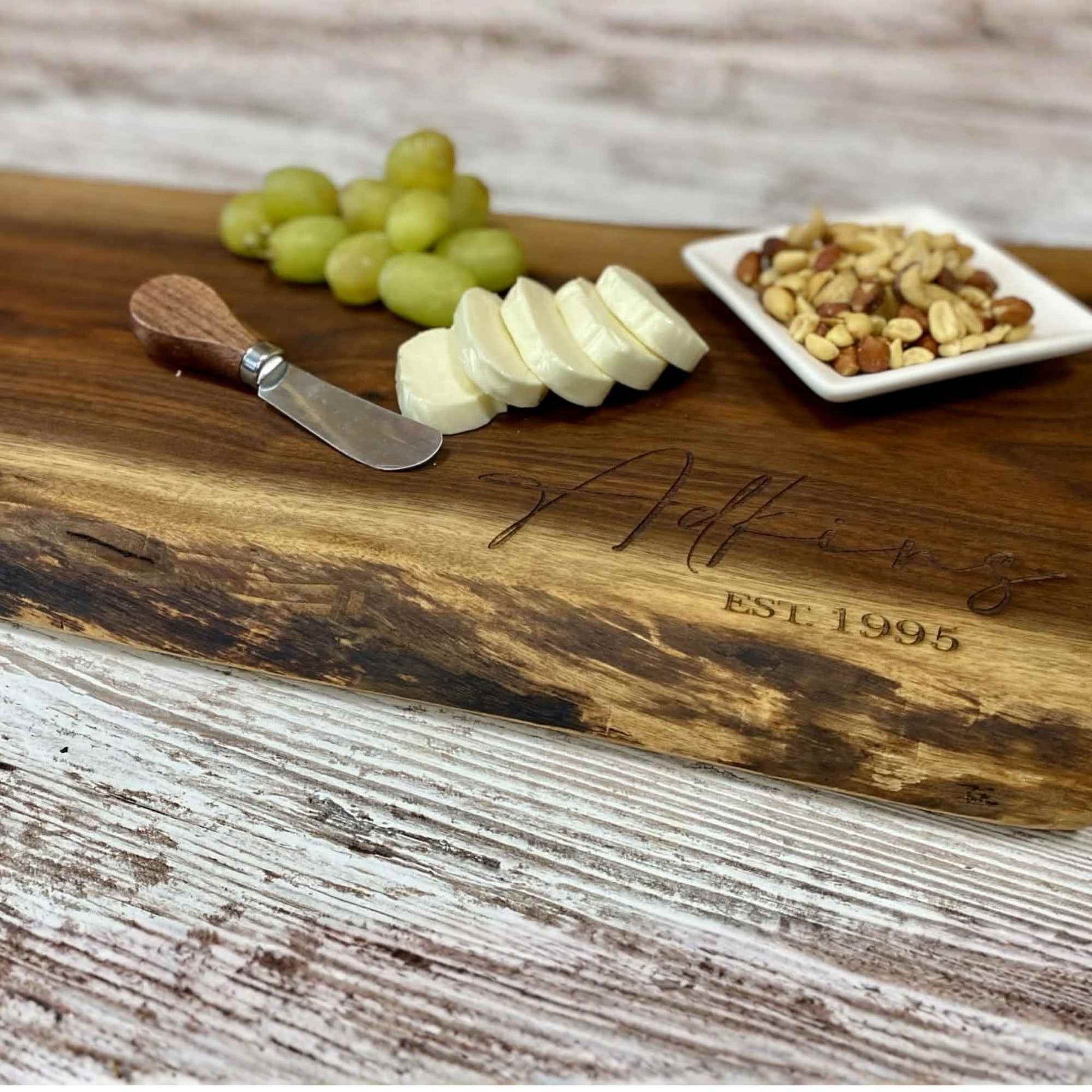 close up of walnut live edge serving board showing the natural edge and grain of the board