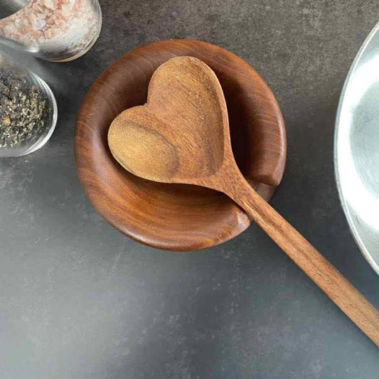 hand turned wood spoon rest sitting on kitchen counter